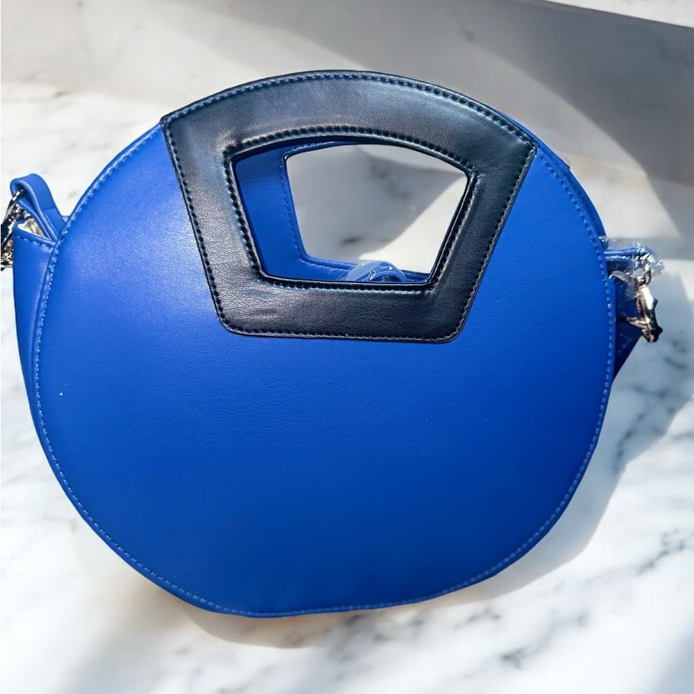 Chic blue round handbag with black accents.
